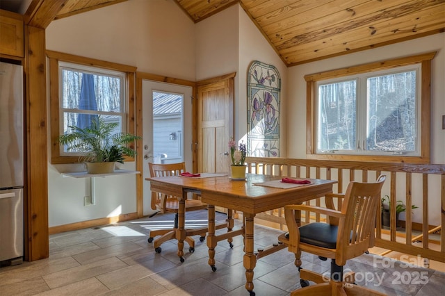 dining room with wooden ceiling, baseboards, and vaulted ceiling