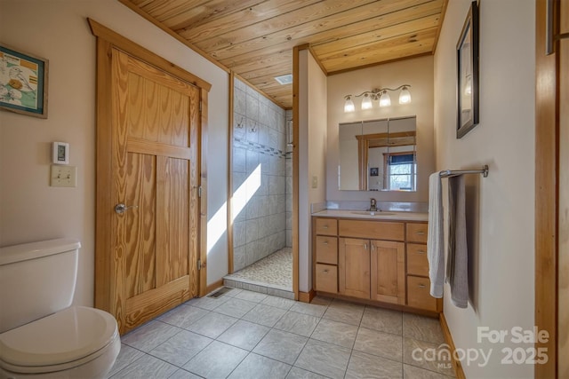 bathroom featuring tile patterned flooring, toilet, vanity, wood ceiling, and tiled shower