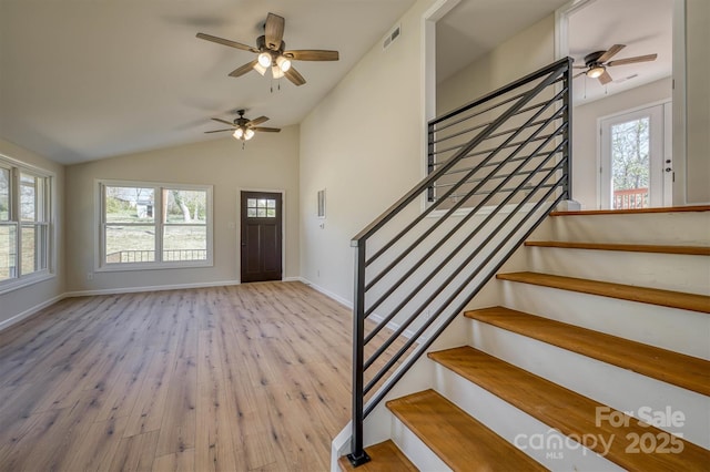 entrance foyer featuring stairway, plenty of natural light, and a ceiling fan