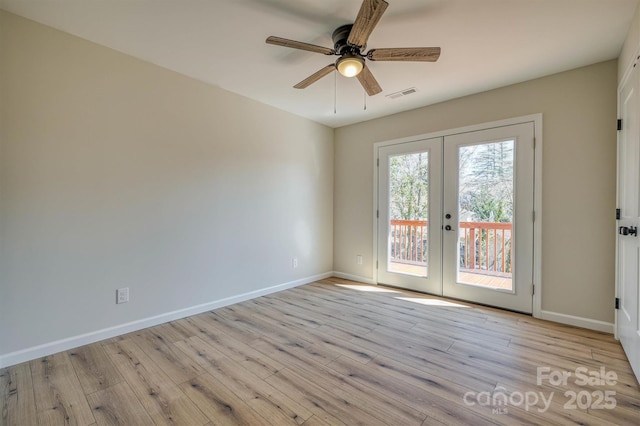 unfurnished room with visible vents, a ceiling fan, french doors, light wood-style floors, and baseboards