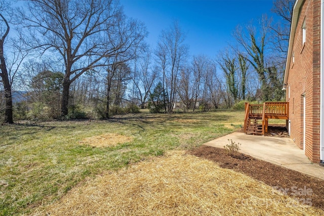 view of yard featuring a patio, stairs, and a deck