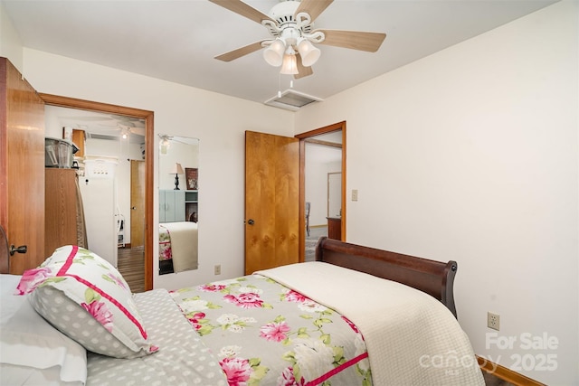 bedroom with attic access and a ceiling fan