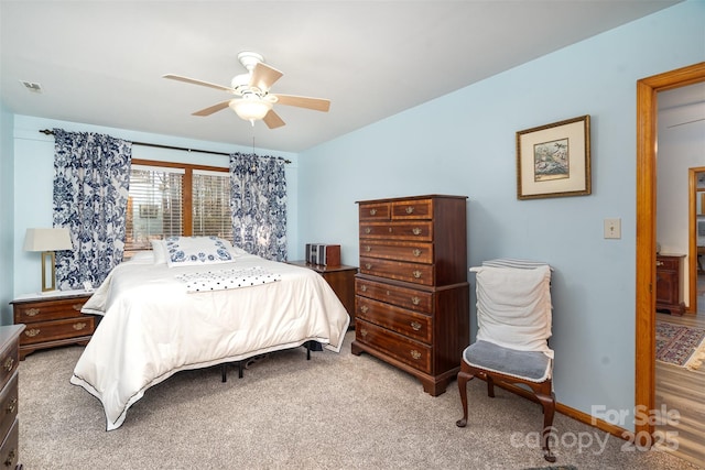 bedroom featuring carpet flooring, ceiling fan, visible vents, and baseboards