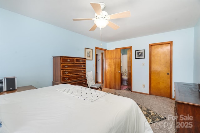 bedroom featuring ensuite bathroom, carpet flooring, a ceiling fan, and baseboards