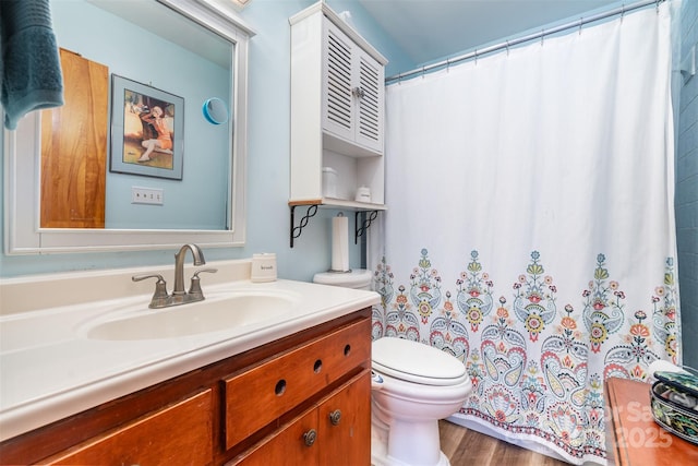 bathroom with wood finished floors, a shower with shower curtain, vanity, and toilet