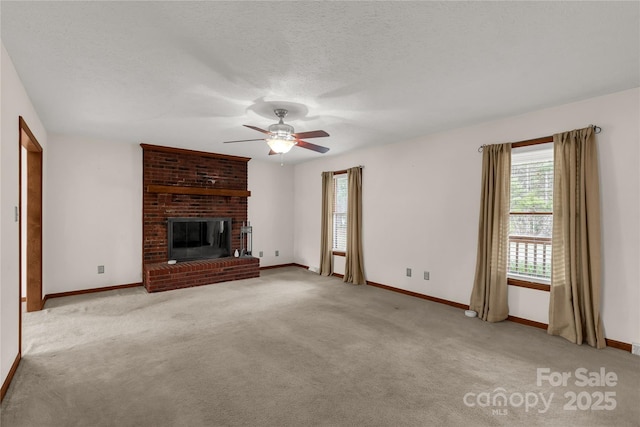 unfurnished living room with light carpet, a textured ceiling, a fireplace, and baseboards