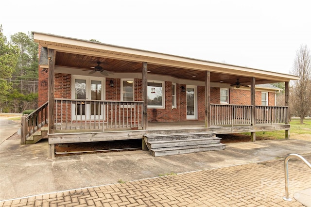 ranch-style home with covered porch, brick siding, and ceiling fan