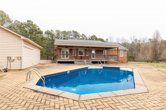 pool featuring a ceiling fan, a patio area, and a deck