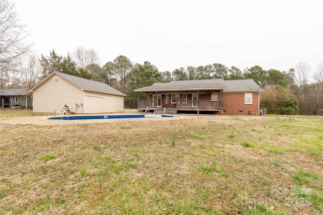 rear view of house featuring brick siding, crawl space, a wooden deck, and a lawn