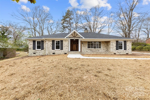 ranch-style house featuring a shingled roof, crawl space, brick siding, and a chimney