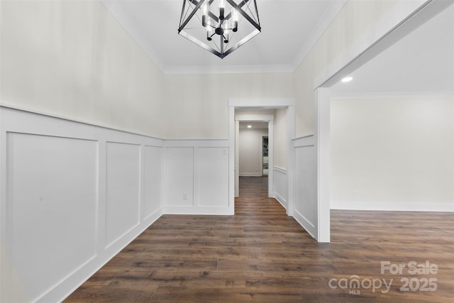 hall with crown molding, a decorative wall, and dark wood-style floors