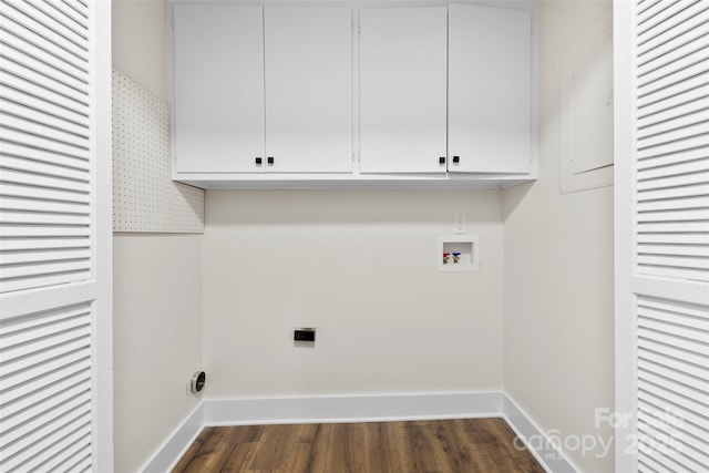 clothes washing area with dark wood-style floors, washer hookup, cabinet space, and baseboards