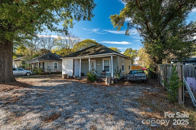 view of front of house featuring a porch and fence