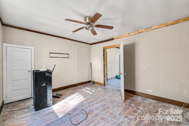 interior space featuring attic access, crown molding, baseboards, and ceiling fan