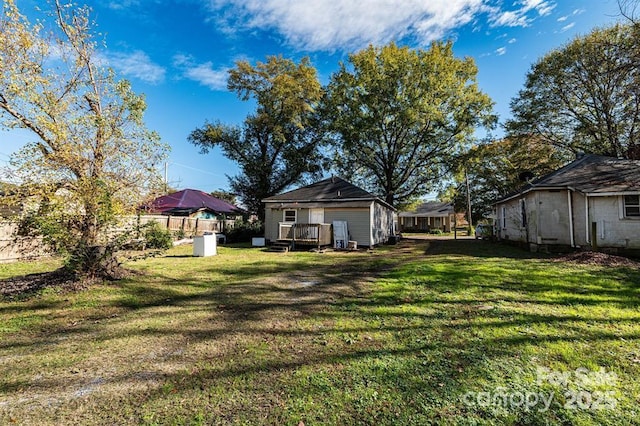 view of yard featuring fence and a deck