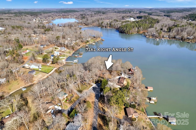 aerial view with a water view and a forest view