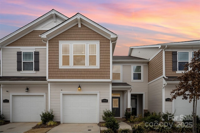 townhome / multi-family property with concrete driveway and an attached garage