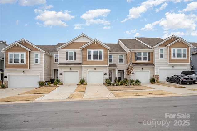 townhome / multi-family property featuring driveway, a garage, and a residential view