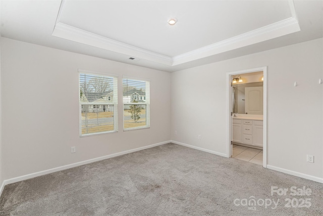 5532 Axil Ln, Charlotte, NC 28269 - unfurnished bedroom with a tray ceiling, crown molding, visible vents, light carpet, and baseboards