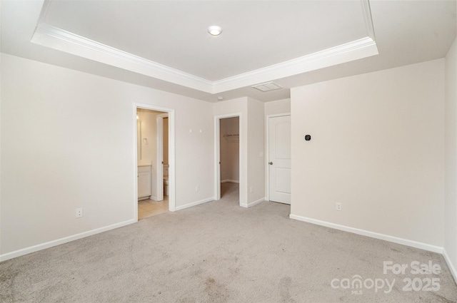 5532 Axil Ln, Charlotte, NC 28269 - unfurnished bedroom featuring a tray ceiling, crown molding, and light colored carpet