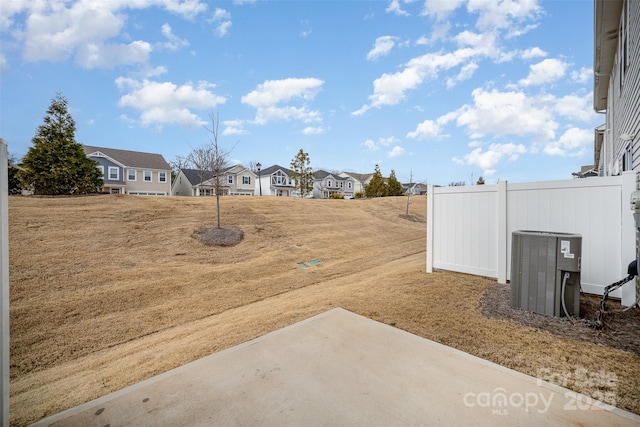 5532 Axil Ln, Charlotte, NC 28269 - view of yard featuring a patio, central AC unit, fence, and a residential view