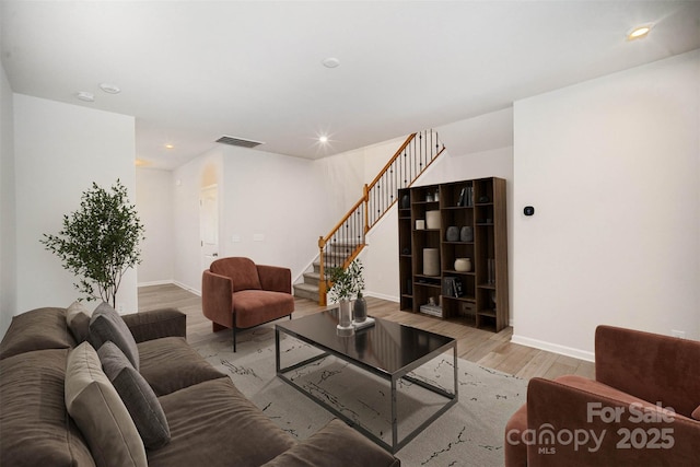 5532 Axil Ln, Charlotte, NC 28269 - living room with stairs, baseboards, wood finished floors, and recessed lighting