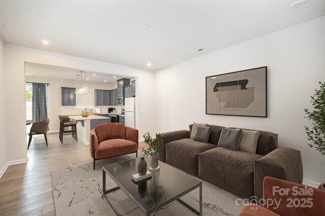 5532 Axil Ln, Charlotte, NC 28269 - living area featuring baseboards, light wood finished floors, and recessed lighting