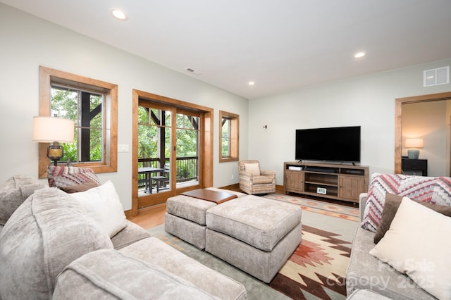 living area featuring recessed lighting, visible vents, and light wood-type flooring