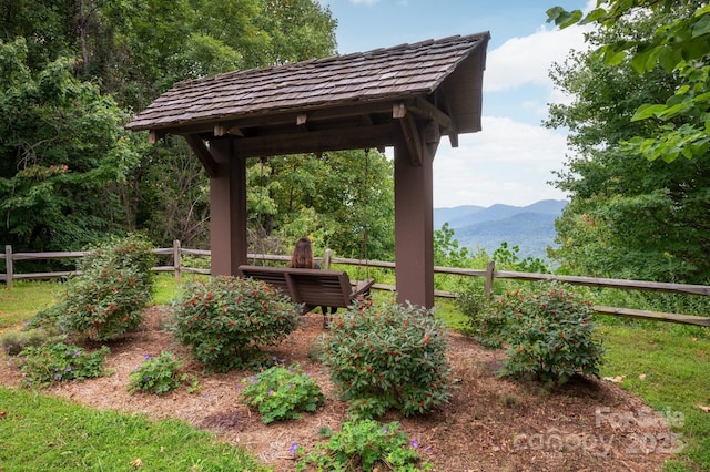 view of yard with a mountain view and fence