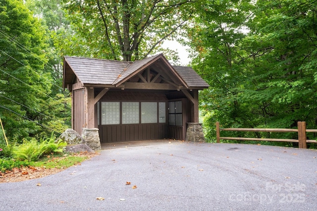 garage with driveway and fence