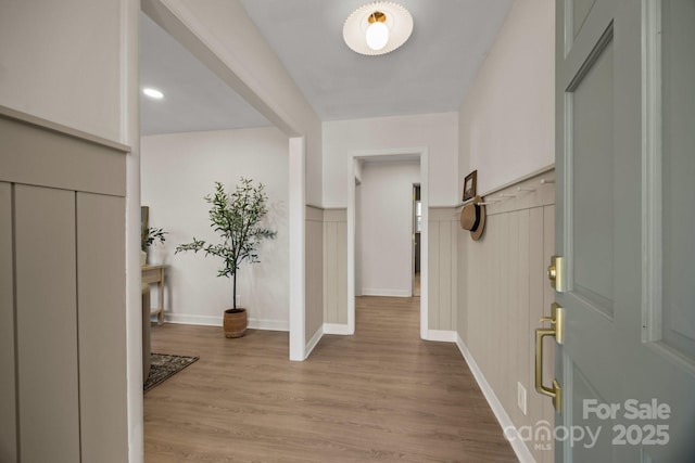 entryway featuring baseboards and wood finished floors