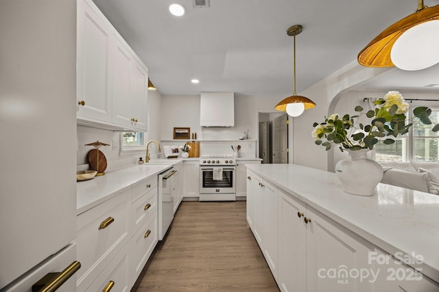 kitchen featuring open shelves, light countertops, white cabinetry, wood finished floors, and white appliances