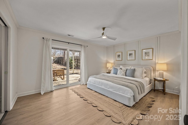 bedroom featuring visible vents, ornamental molding, wood finished floors, access to outside, and baseboards