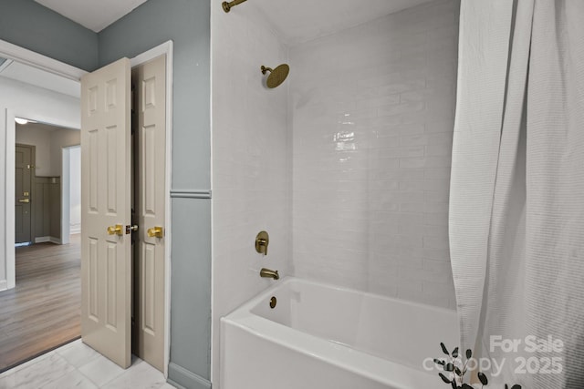 full bathroom with baseboards and shower / bathtub combination with curtain