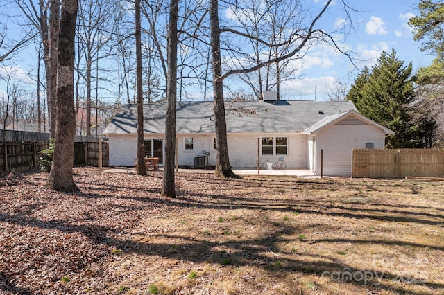 view of front of home featuring a chimney, a patio, central AC unit, and fence