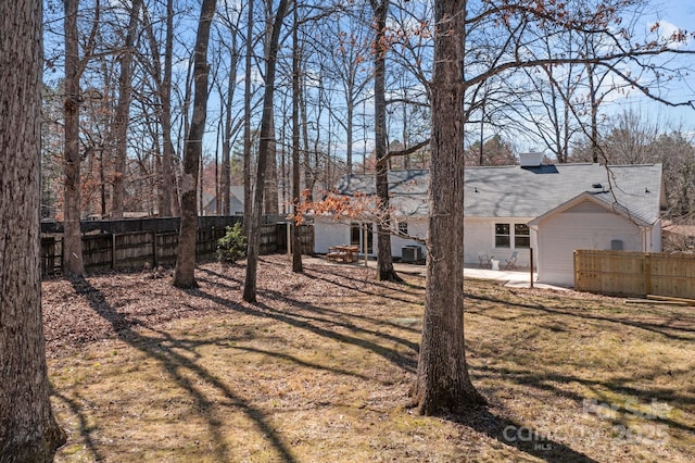 view of yard featuring a patio area, fence, and cooling unit