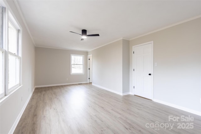 unfurnished room with ornamental molding, baseboards, wood finished floors, and ceiling fan