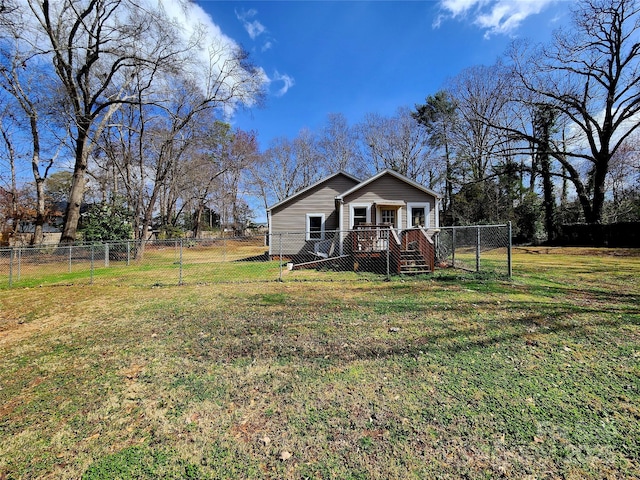 view of front of property with a front yard, a fenced backyard, and a gate