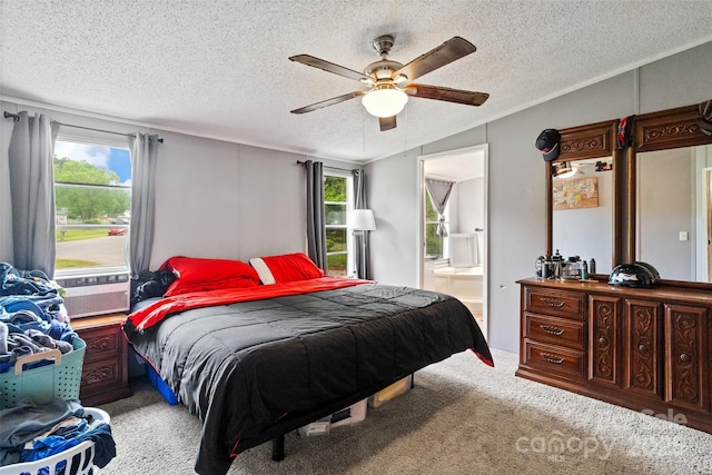 carpeted bedroom with connected bathroom, a textured ceiling, a ceiling fan, and cooling unit