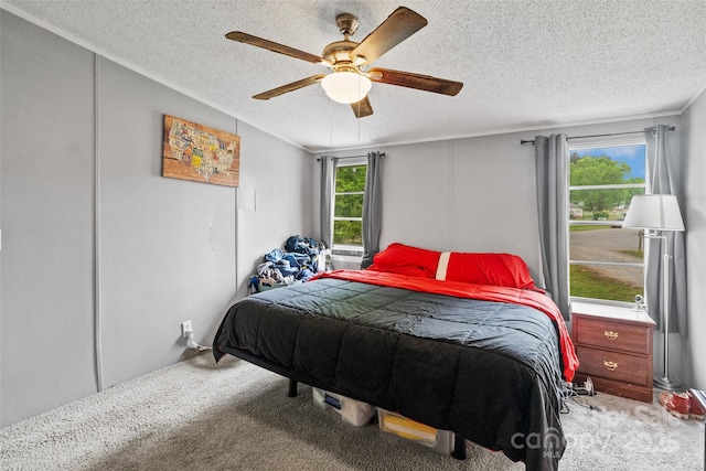 bedroom featuring carpet flooring, a textured ceiling, and ceiling fan