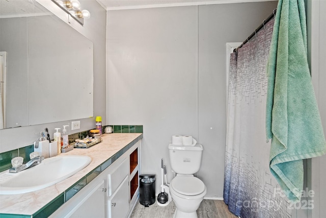 full bath with vanity, wood finished floors, curtained shower, toilet, and baseboards