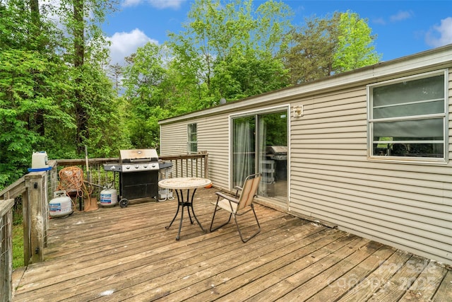 wooden deck with a grill