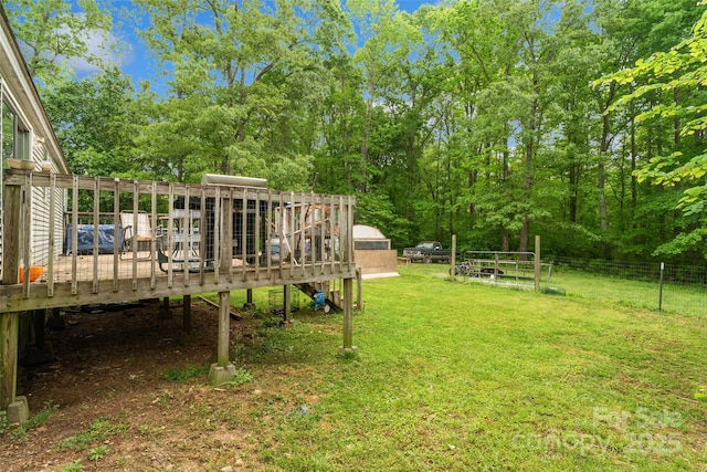 view of yard with a deck and fence