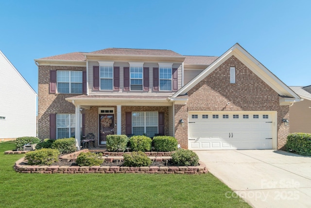 view of front facade featuring brick siding, driveway, an attached garage, and a front lawn