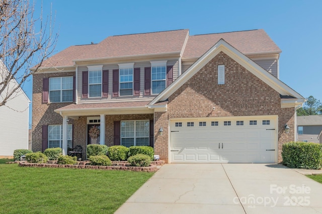 view of front of house with a front lawn, an attached garage, brick siding, and driveway