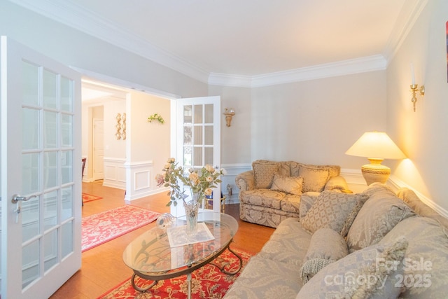 living area featuring crown molding and wood finished floors