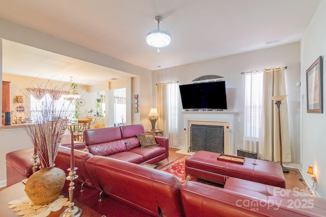 living area featuring visible vents and a fireplace