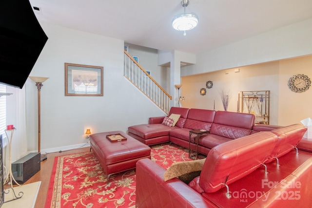 living area with stairs and baseboards