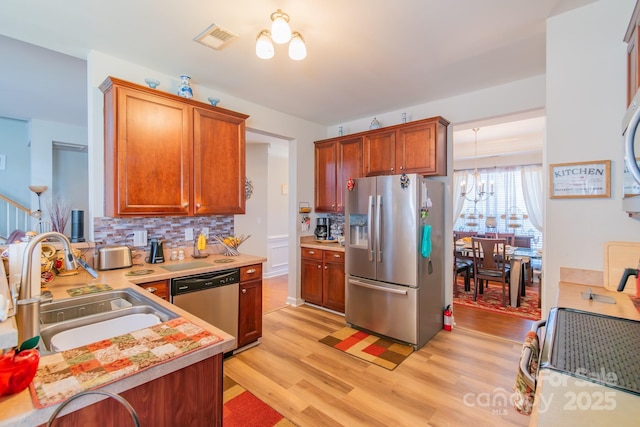 kitchen with light countertops, visible vents, appliances with stainless steel finishes, and a sink