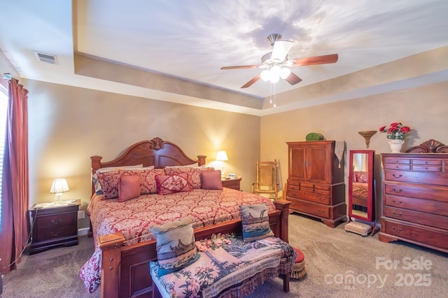 bedroom featuring light carpet, visible vents, and a ceiling fan